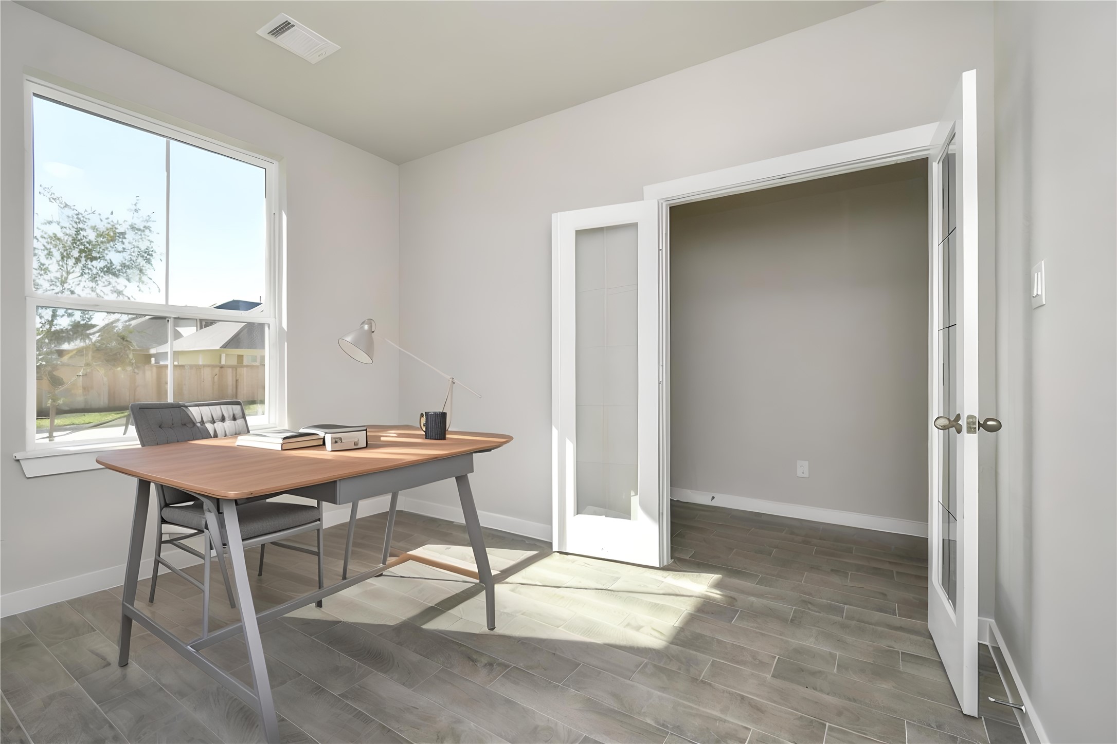 15111 Statice Trail Houston, TX 77044 - Photo 10 of 35 a view of a workspace with furniture and a window