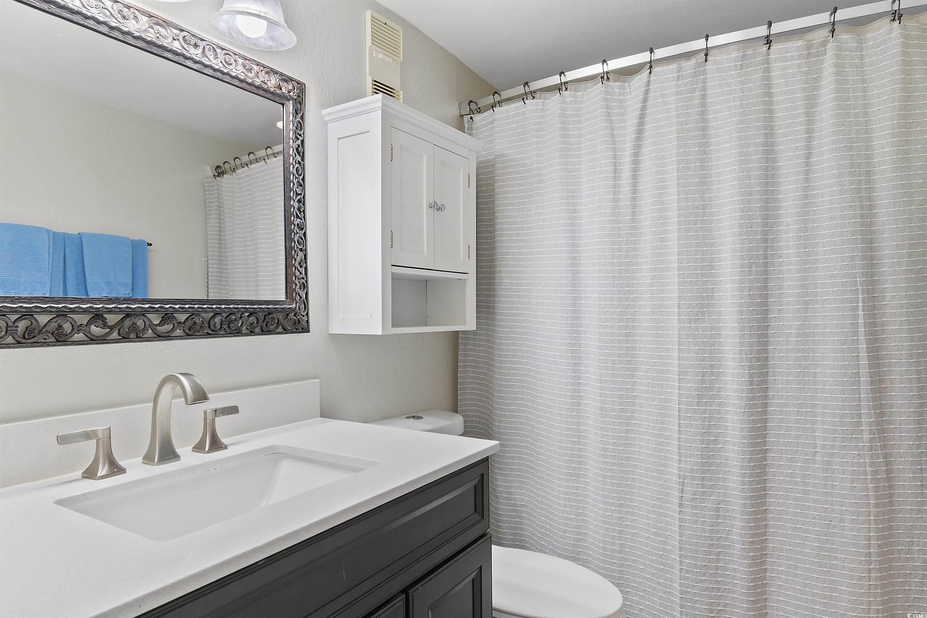 1012 North Waccamaw Drive, Unit 1504 Murrells Inlet, SC 29576 - Photo 8 of 18 Bathroom featuring vanity and toilet