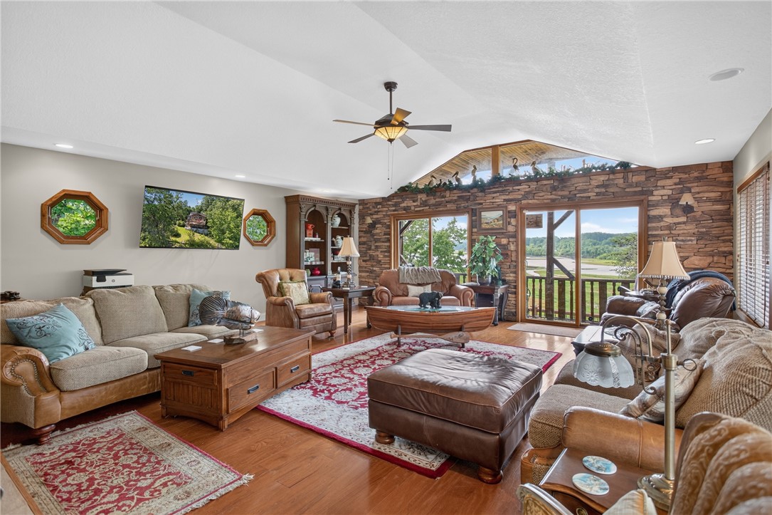351 River Road Westminster, SC 29693 - Photo 6 of 50 A spacious living area features vaulted ceiling and sliding glass doors revealing scenic views.
