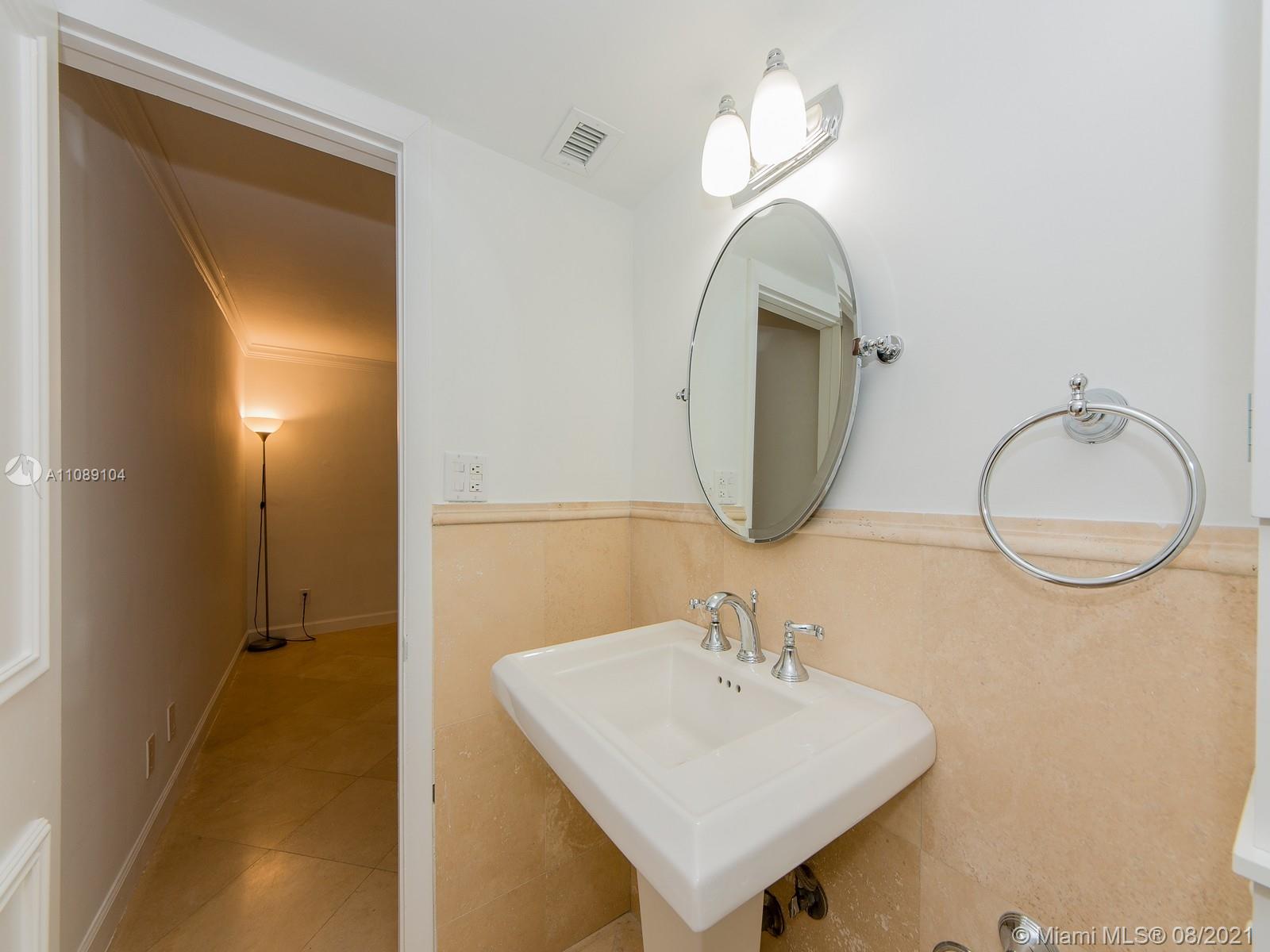 605 Ocean Drive, Unit 2L Key Biscayne, FL 33149 - Photo 13 of 18 a bathroom with a sink and a mirror