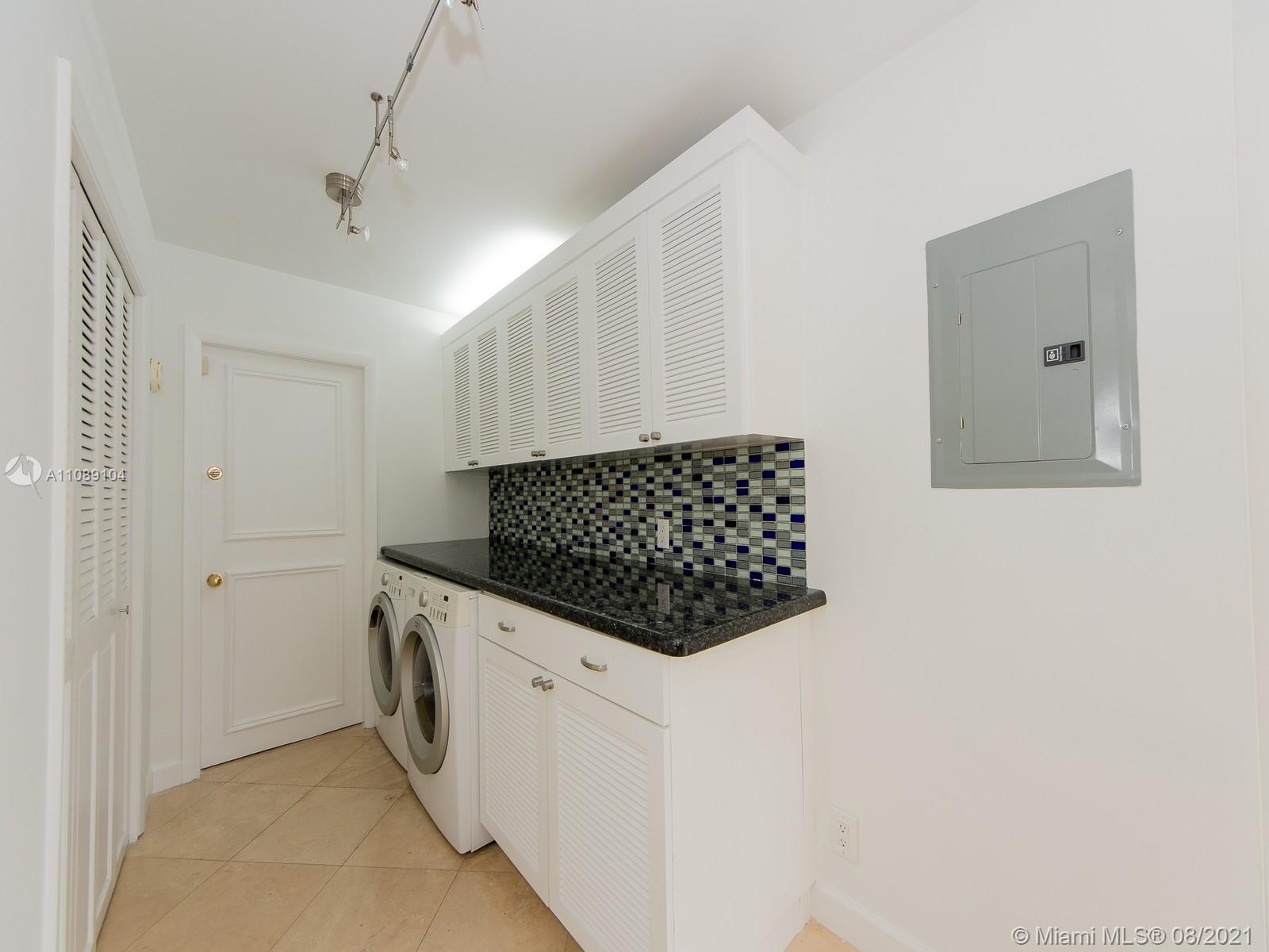 605 Ocean Drive, Unit 2L Key Biscayne, FL 33149 - Photo 5 of 18 a kitchen with stainless steel appliances a refrigerator and a stove