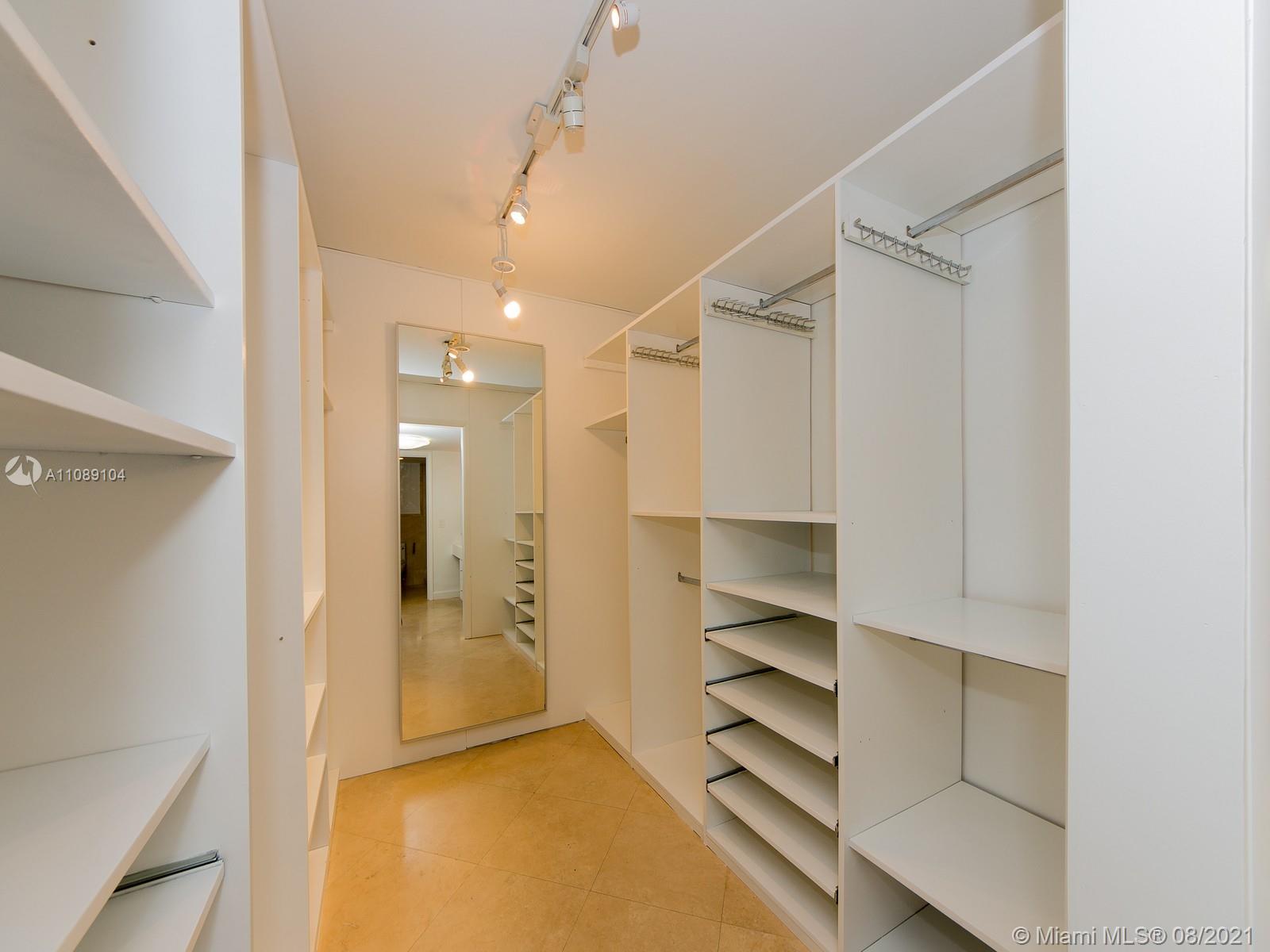 605 Ocean Drive, Unit 2L Key Biscayne, FL 33149 - Photo 8 of 18 a view of walk in closet with empty racks
