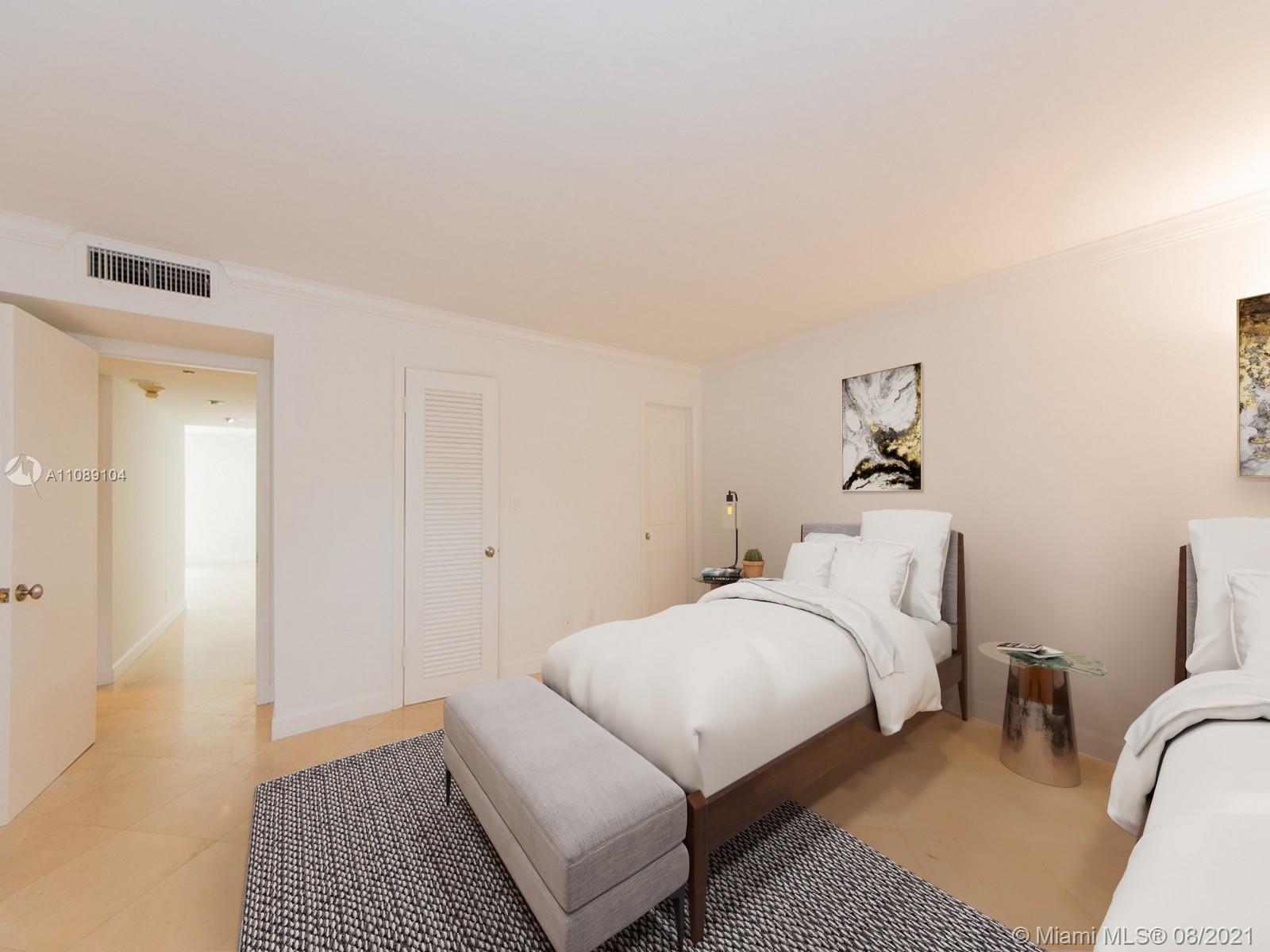 605 Ocean Drive, Unit 2L Key Biscayne, FL 33149 - Photo 10 of 18 a bedroom with a bed and a couch