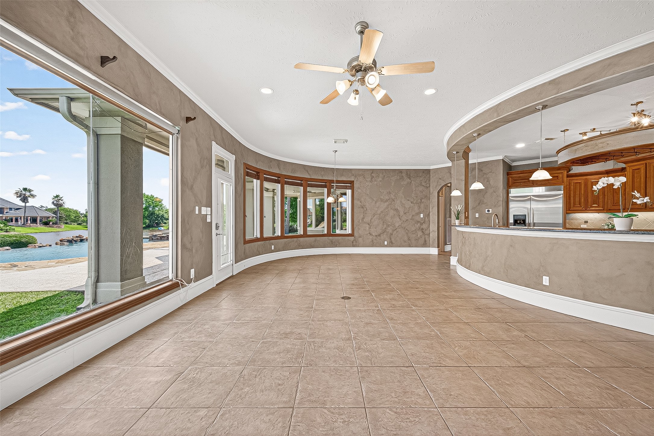 25626 Windy Isle Court Spring, TX 77389 - Photo 14 of 45 This spacious, open-concept living area features large windows with stunning views of the backyard with the heated pool/spa, covered patio and the surrounding lake. What a wonderful way to start each day!