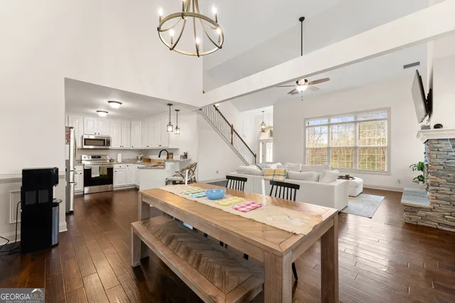 a kitchen with stainless steel appliances granite countertop a stove top oven a sink refrigerator and a stove