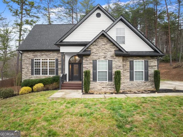 a front view of a house with garden