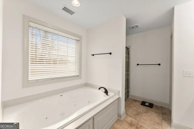 a bathroom with mirror and vanity