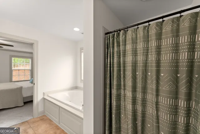 a en suite bathroom with a granite countertop double sink and mirror