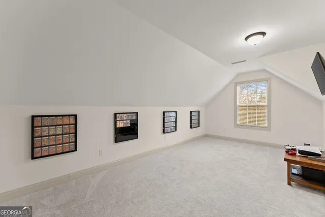 a view of a room with gym equipment and a flat screen tv