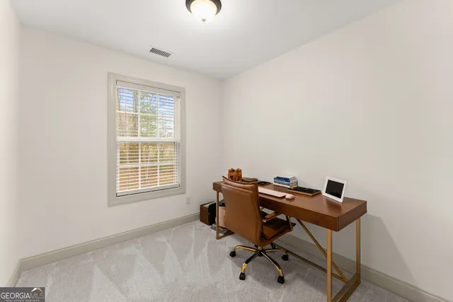a view of a livingroom with a workspace