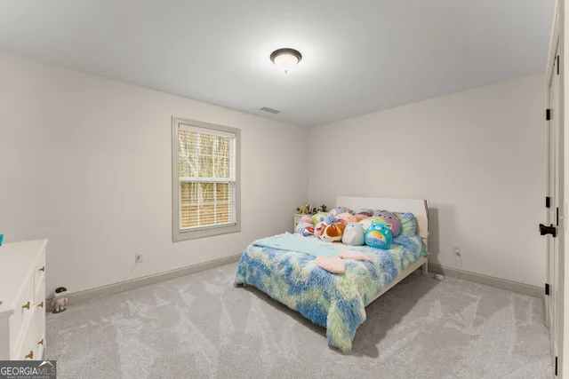 a bed room with a bed and a window