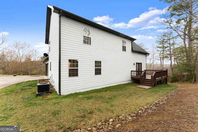 a backyard of a house with a garden and barbeque oven