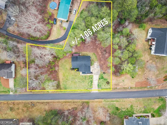 a view of a house with a yard and sitting area