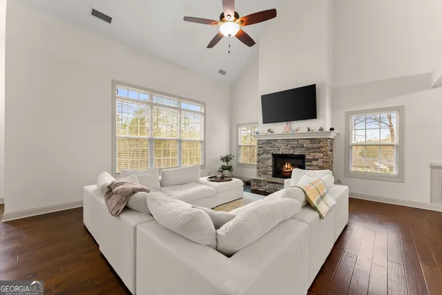 a living room with furniture and a chandelier