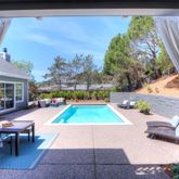 a view of a swimming pool with seating space