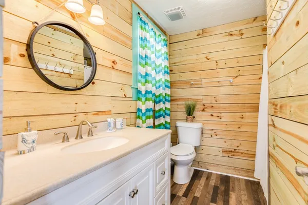 a white toilet sitting next to a bathroom sink