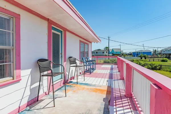a view of a chairs and table in the balcony