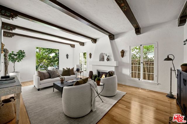 a living room with furniture fireplace and a flat screen tv
