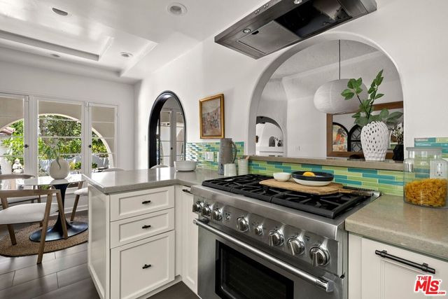 a kitchen with stainless steel appliances granite countertop a stove and a sink