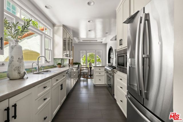 a large kitchen with cabinets and stainless steel appliances