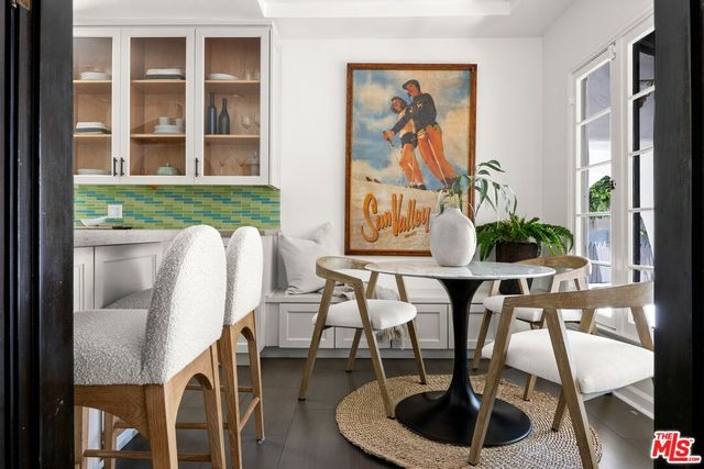 a dining room with furniture and a floor to ceiling window