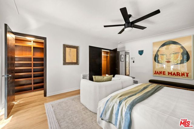 a bedroom with a bed and a walk in closet