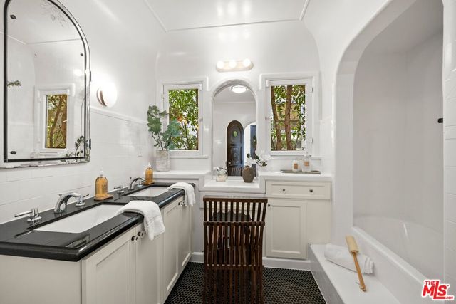 a bathroom with a sink a vanity and a mirror