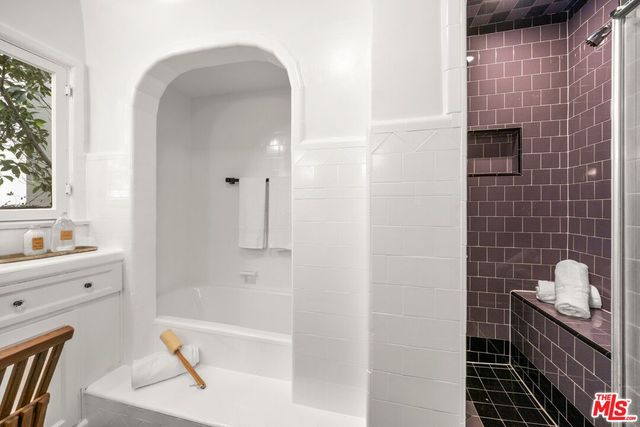 a bathroom with a bathtub and a sink