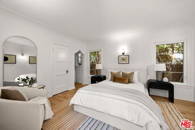 a bedroom with a bed couch and window