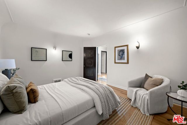 a bedroom with bed and a couch