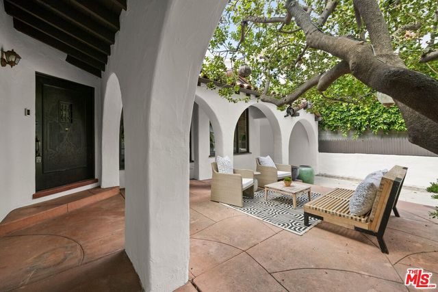 a building outdoor space with patio furniture and potted plants