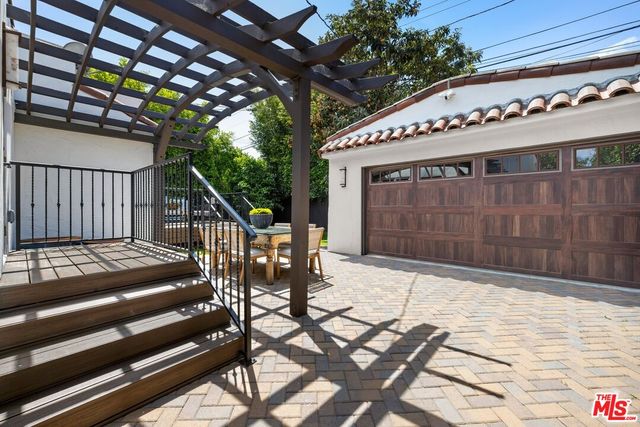 a roof deck with table and chairs