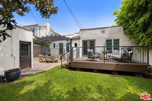 a view of a house with patio and a yard