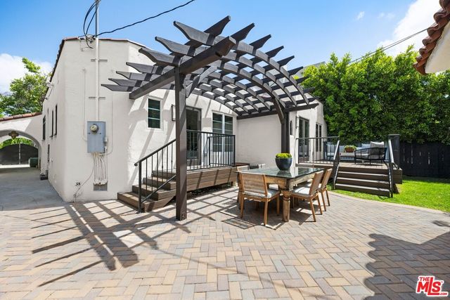 a view of a patio with a table and chairs