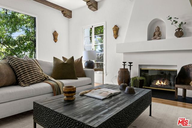 a living room with furniture fireplace and window
