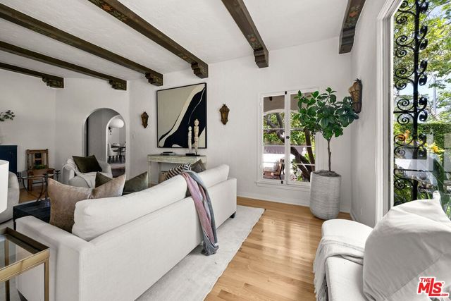 a view of living room filled with furniture and a potted plant