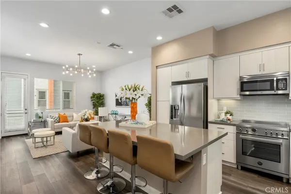a kitchen with sink refrigerator and stove