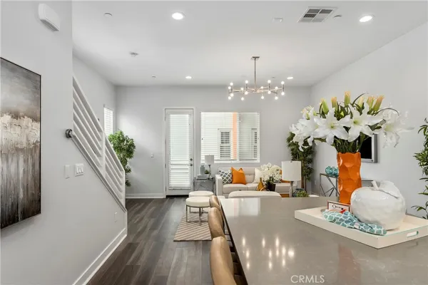 a dining room filled with furniture and a chandelier