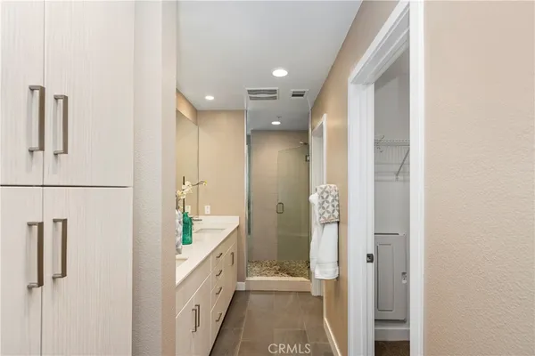 a bathroom with a double vanity sink and a mirror