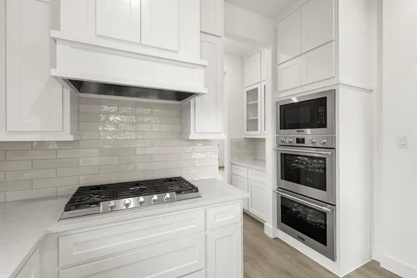a kitchen with a stove and a microwave