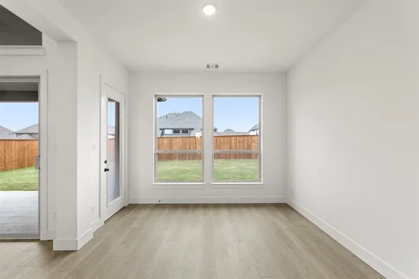 an empty room with windows and closet