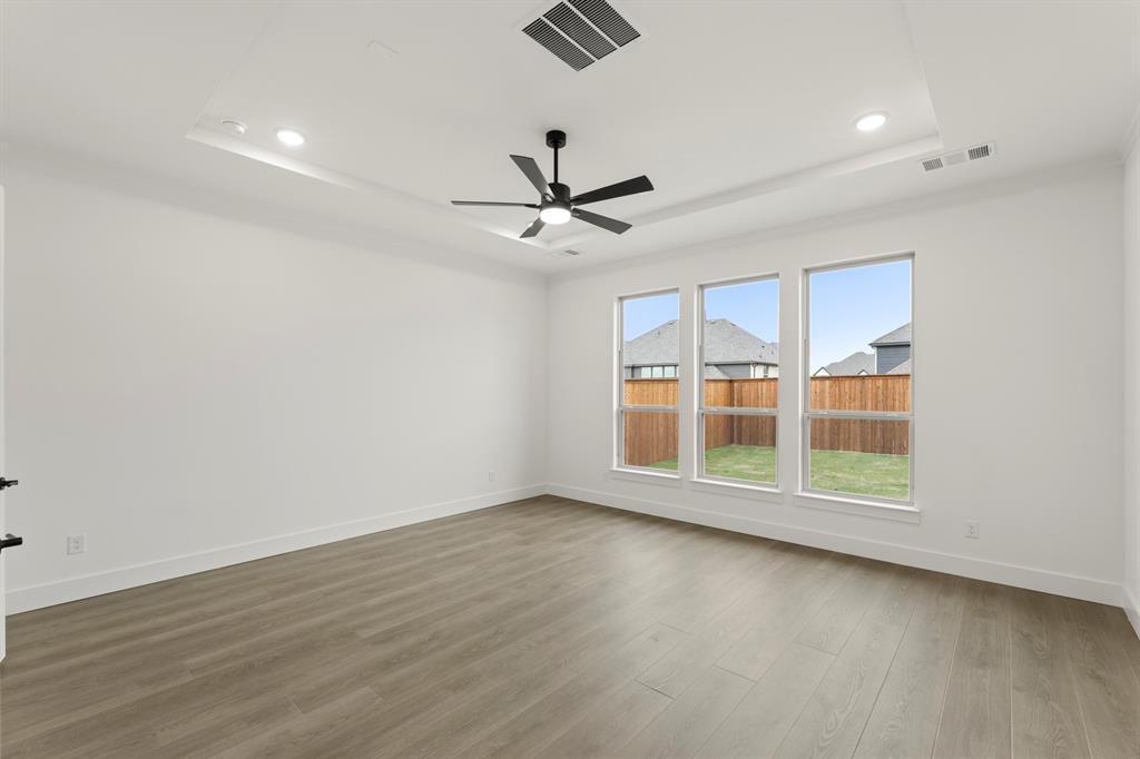 1061 Georgetown Place Prosper, TX 75078 - Photo 15 of 29 wooden floor in an empty room with a window