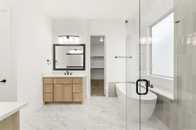 an empty room with chandelier fan and windows