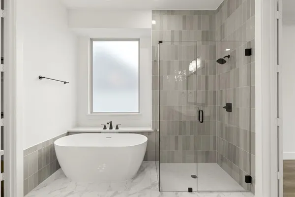 a bathroom with a bathtub and shower