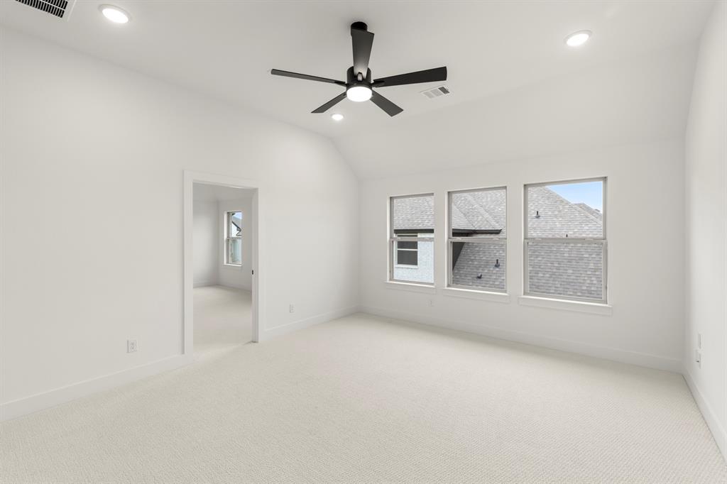 1061 Georgetown Place Prosper, TX 75078 - Photo 22 of 29 an empty room with chandelier fan and windows