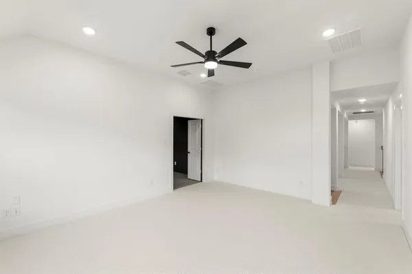 an empty room with closet and a ceiling fan