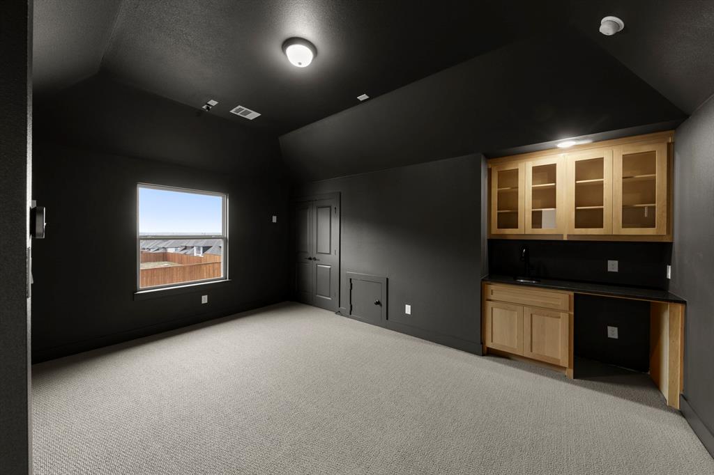 1061 Georgetown Place Prosper, TX 75078 - Photo 24 of 29 a view of an empty room with a window and a kitchen