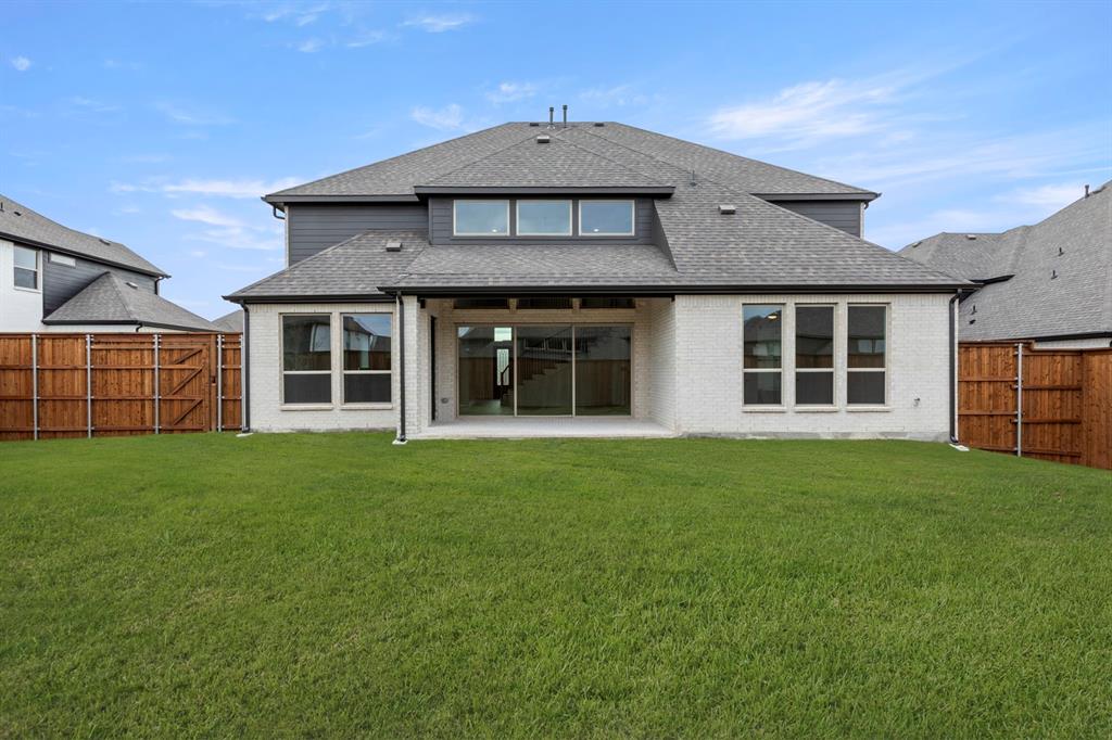 1061 Georgetown Place Prosper, TX 75078 - Photo 26 of 29 a front view of a house with a garden
