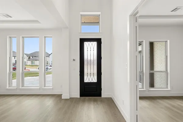 a view of an entryway with wooden floor