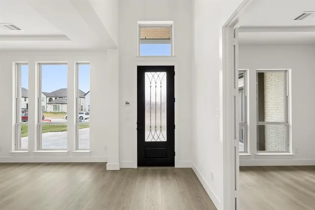 a view of an entryway with wooden floor